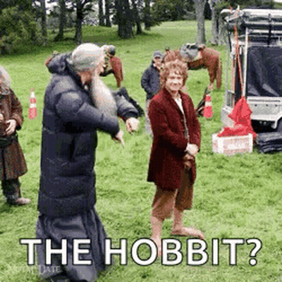 A Group Of People Standing In A Grassy Field With The Words `` The Hobbit '' Written On It . GIF