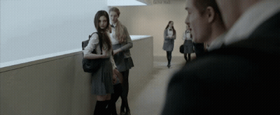 A Group Of People Standing In A Hallway With A Sign On The Wall That Says Do N't Enter GIF