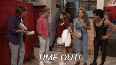 A Group Of People Standing In A Hallway With The Words Time Out Written On The Floor GIF
