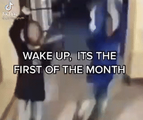 A Group Of People Standing In A Hallway With The Words `` Wake Up , It 'S The First Of The Month '' GIF