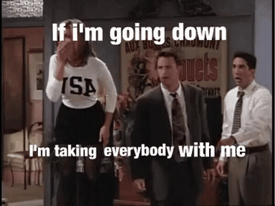 A Group Of People Standing In A Room With The Caption If I 'M Going Down I 'M Taking Everyone With Me GIF