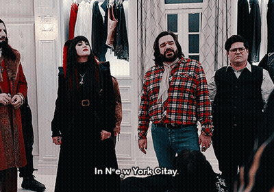 A Group Of People Standing In A Room With The Words In New York Citay On The Bottom GIF
