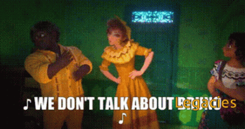 A Group Of People Standing In A Room With The Words We Don 'T Talk About Legacies Written Above Them GIF