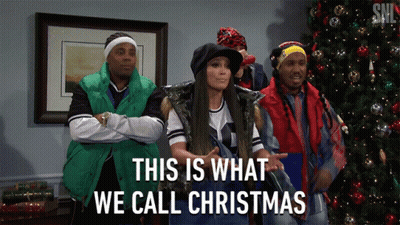 A Group Of People Standing In Front Of A Christmas Tree With The Words This Is What We Call Christmas GIF