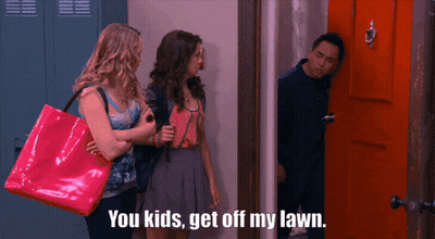 A Group Of People Standing In Front Of A Door With The Words You Kids Get Off My Lawn GIF