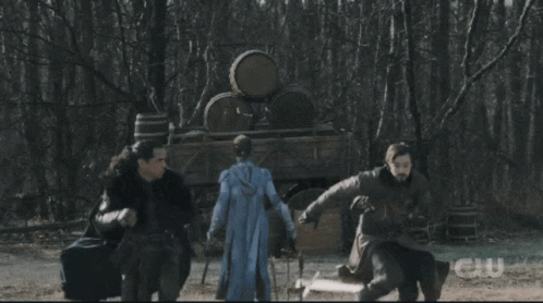 A Group Of People Standing In Front Of A Large Explosion With The Letters Cw On The Bottom GIF