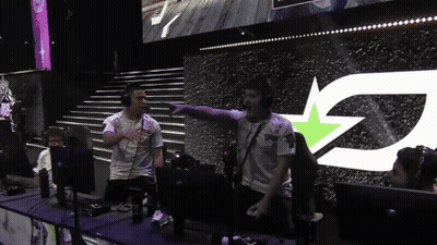 A Group Of People Standing In Front Of A Large Screen With The Letter Z GIF