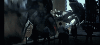 A Group Of People Standing In Front Of A Large Statue GIF