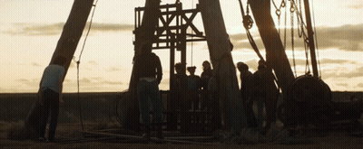 A Group Of People Standing In Front Of A Large Structure That Says ' A ' On It GIF