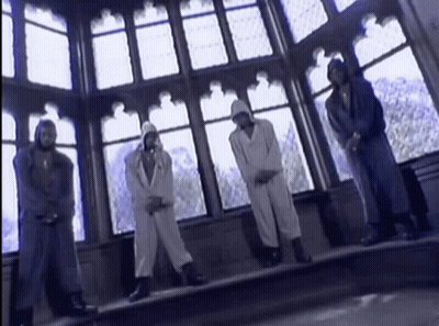 A Group Of People Standing In Front Of A Large Window GIF