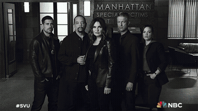 A Group Of People Standing In Front Of A Manhattan Special Victims Unit Sign GIF