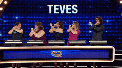 A Group Of People Standing In Front Of A Screen That Says Teves On It GIF