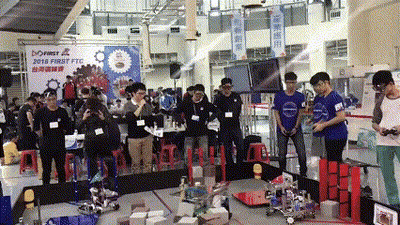 A Group Of People Standing In Front Of A Sign That Says 2018 First Ftc GIF
