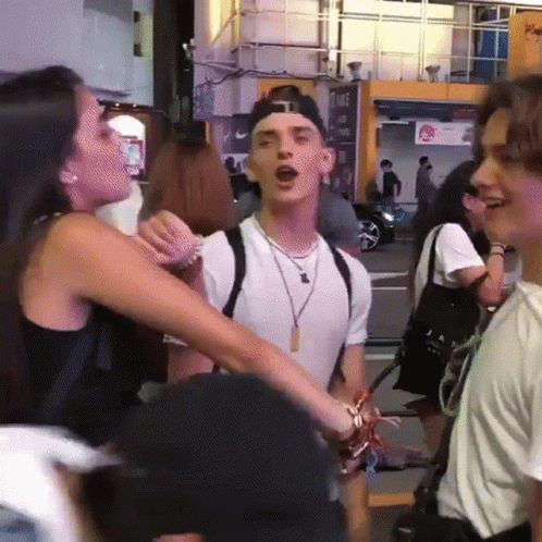 A Group Of People Standing In Front Of A Sign That Says ' A ' On It GIF