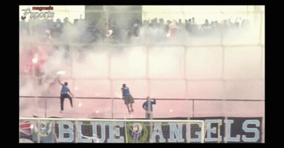 A Group Of People Standing In Front Of A Sign That Says " Blue Angels " GIF