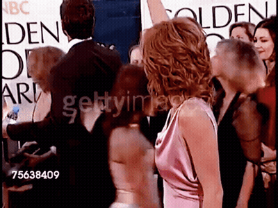 A Group Of People Standing In Front Of A Sign That Says Golden Globe Awards GIF