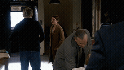 A Group Of People Standing In Front Of A Sign That Says Goods Only GIF