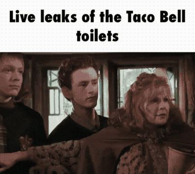 A Group Of People Standing In Front Of A Sign That Says " Live Leaks Of The Taco Bell Toilets " GIF