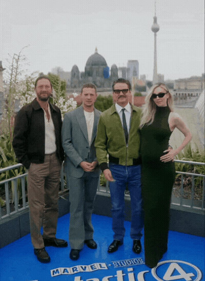 A Group Of People Standing In Front Of A Sign That Says Marvel Studios Fantastic Four GIF