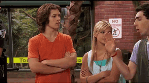 A Group Of People Standing In Front Of A Sign That Says No Standing GIF