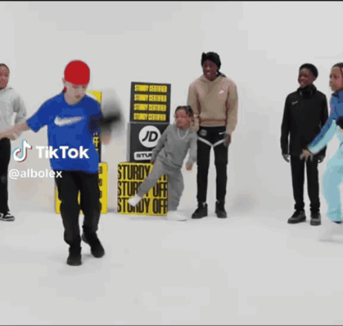 A Group Of People Standing In Front Of A Sturdy Certified Sign GIF