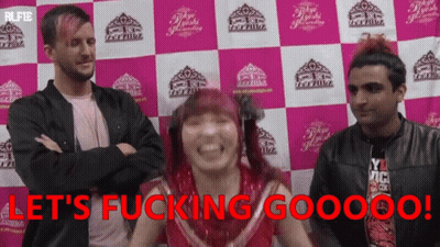 A Group Of People Standing In Front Of A Wall That Says Let 'S Fucking Gooooo ! GIF