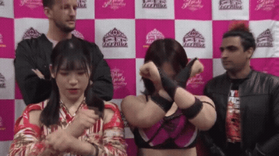 A Group Of People Standing In Front Of A Wall That Says Tokyo GIF