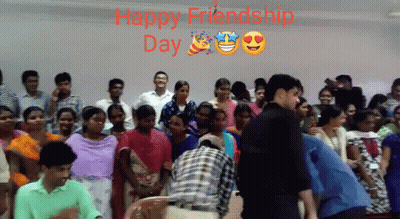 A Group Of People Standing In Front Of A Wall With The Words Happy Friendship Day Written Above Them GIF