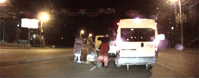 A Group Of People Standing In Front Of A White Van That Says ' Ambulance ' On It GIF