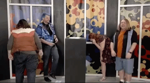 A Group Of People Standing In Front Of A Window With A Woman Laughing GIF