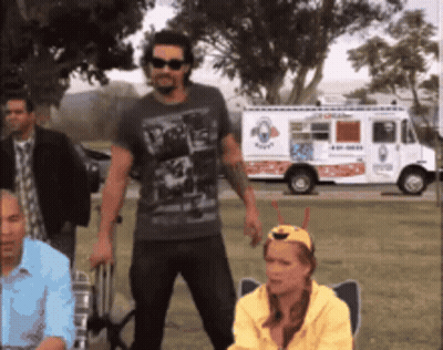 A Group Of People Standing In Front Of An Ice Cream Truck That Says Ice Cream GIF