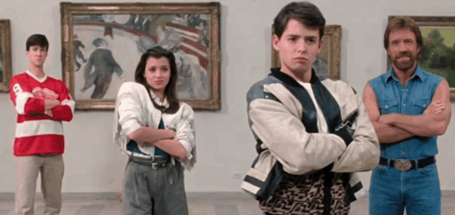 A Group Of People Standing In Front Of Paintings One Of Whom Is Wearing A Red And White Jersey That Says Toronto GIF