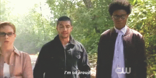 A Group Of People Standing Next To Each Other And One Of Them Says I 'M So Proud GIF