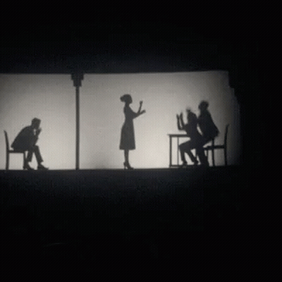 A Group Of People Standing Next To Each Other On A Stage GIF