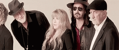 A Group Of People Standing Next To Each Other Wearing Hats . GIF