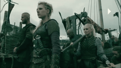 A Group Of People Standing Next To Each Other With The Number 12 On Their Sleeves GIF