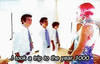 A Group Of People Standing Next To Each Other With The Words I Took A Trip To The Year 3000 GIF