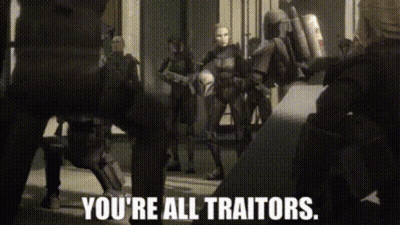 A Group Of People Standing Next To Each Other With The Words `` You 'Re All Traitors '' Written On The Screen . GIF