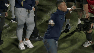 A Group Of People Standing On A Field With Espn On The Bottom GIF