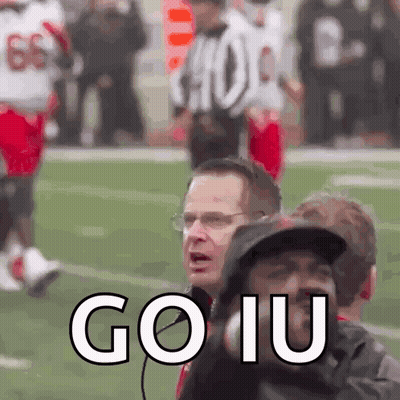 A Group Of People Standing On A Football Field With The Words Go Iu Written On The Bottom GIF