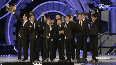 A Group Of People Standing On A Stage With The Word Mama On The Bottom GIF