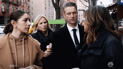 A Group Of People Standing On A Street With The Nbc Logo On The Bottom Left GIF