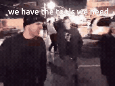 A Group Of People Standing On A Street With The Words We Have The Tools We Need GIF