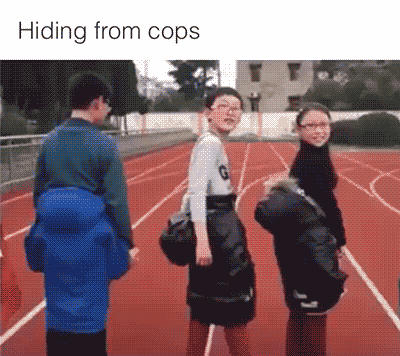 A Group Of People Standing On A Track With The Words Hiding From Cops Below Them GIF