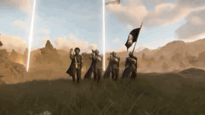 A Group Of People Standing On Top Of A Grass Covered Field Holding Flags . GIF