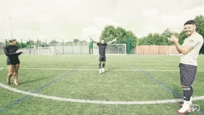 A Group Of People Standing On Top Of A Soccer Field Applauding . GIF