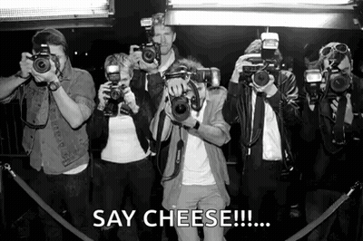 A Group Of People Taking Pictures With Cameras And The Caption Say Cheese GIF
