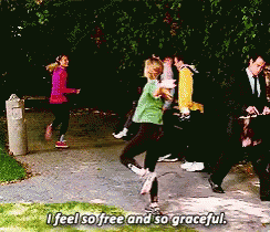 A Group Of People Walking Down A Sidewalk With The Words " I Feel So Free And So Graceful " GIF