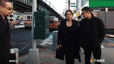 A Group Of People Walking Down A Street With A Nbc Logo On The Bottom GIF