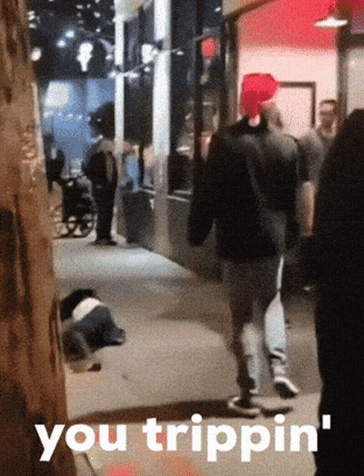 A Group Of People Walking Down A Street With The Words You Trippin ' On The Bottom Right GIF